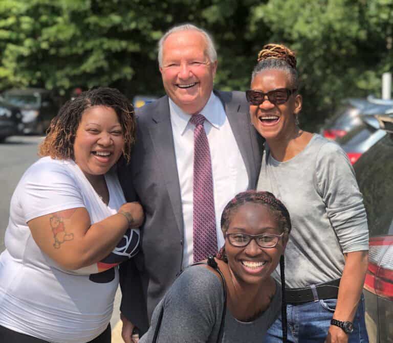 Dr. Ireland smiling with members of our DSP team.