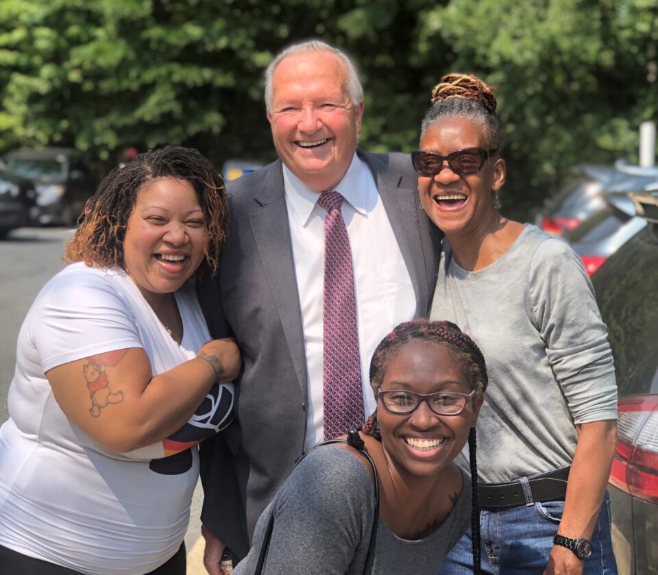 Dr. Ireland smiling with members of our DSP team.
