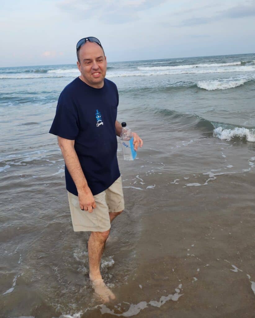 Bello Machre individual enjoying the sand and surf at the beach.