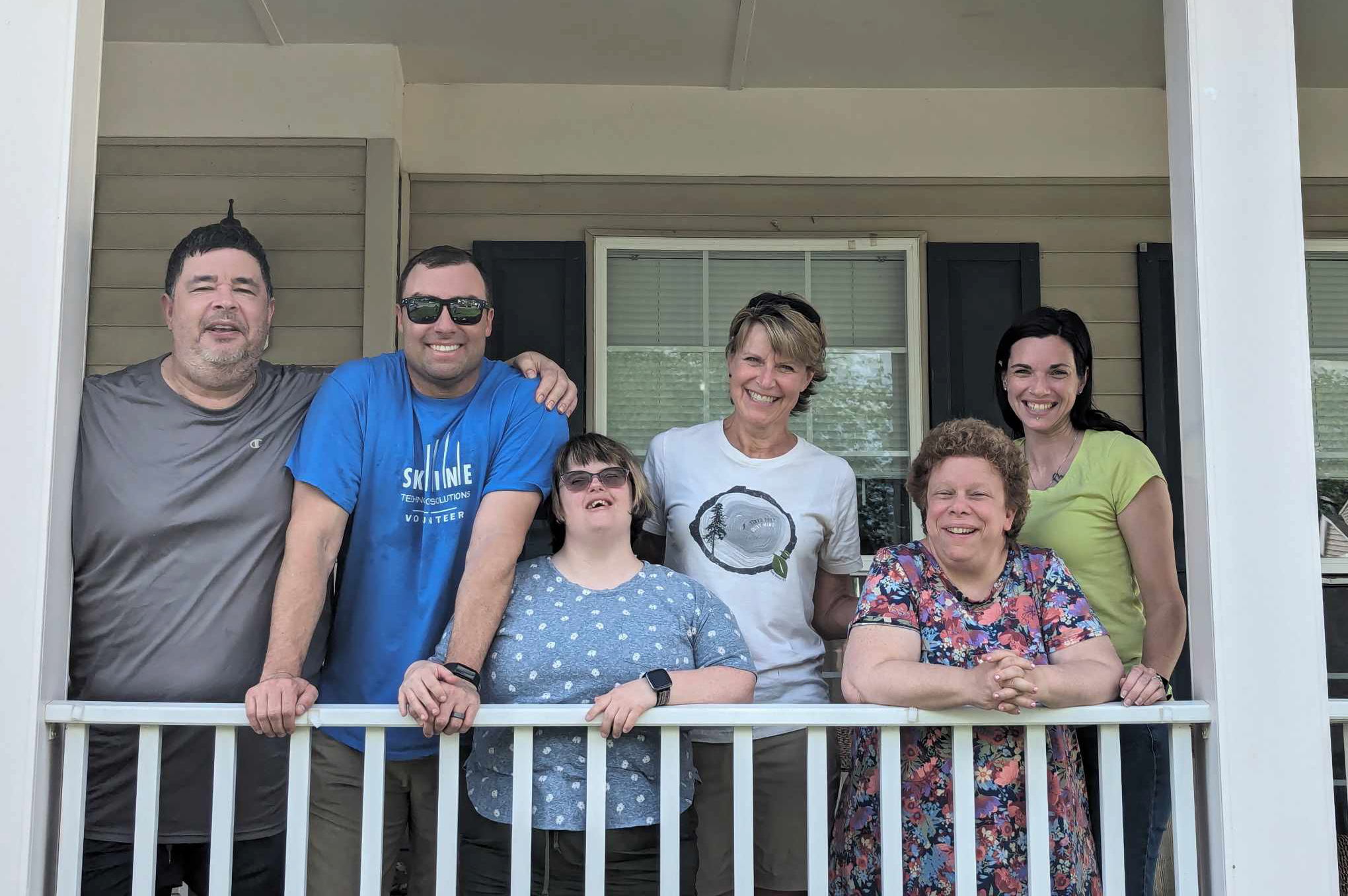 Residents and Guests of Group Home on Porch Smiling