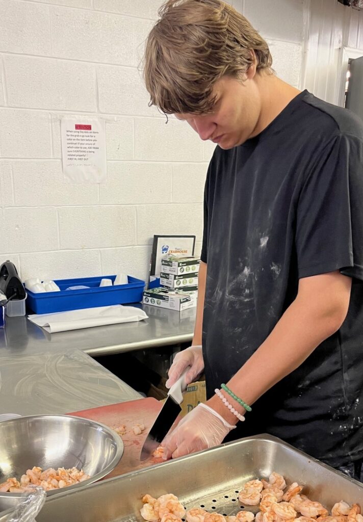 Culinary worker preparing food