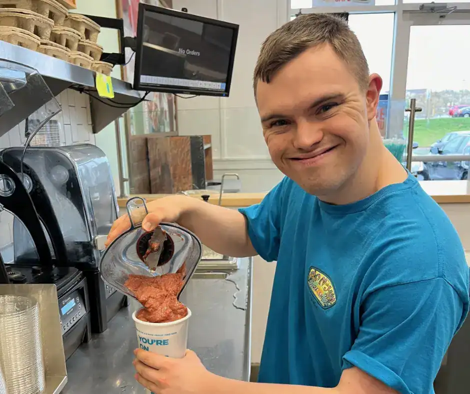 Bello Machre individual on the job serving smoothies.
