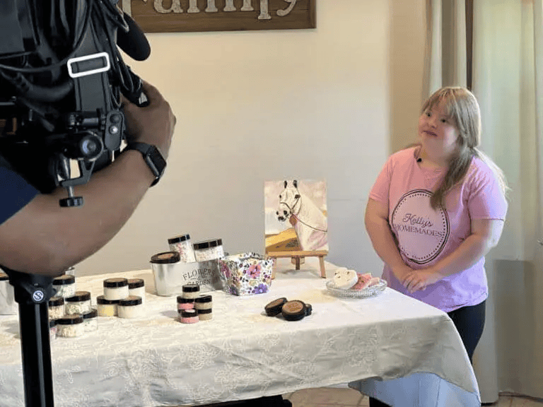 Kelly showing off her products during a TV interview