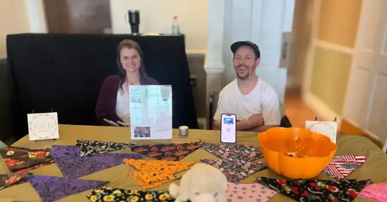 Billy and his support staff selling handmade pet bandanas at their vendor booth