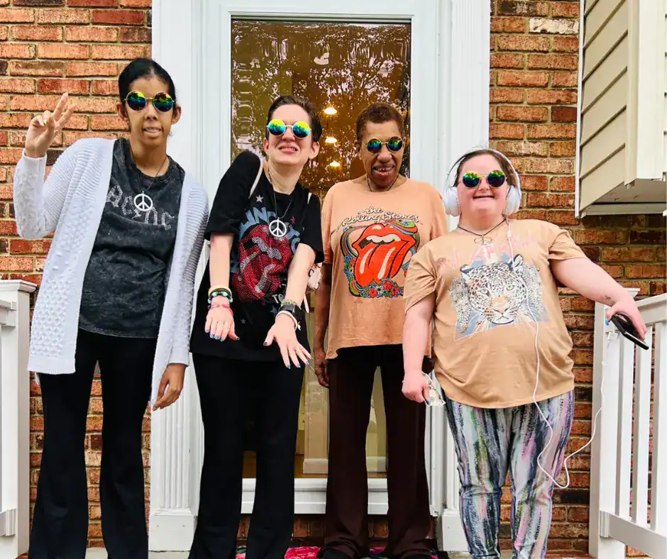 Residents of a group home posting together, having fun.