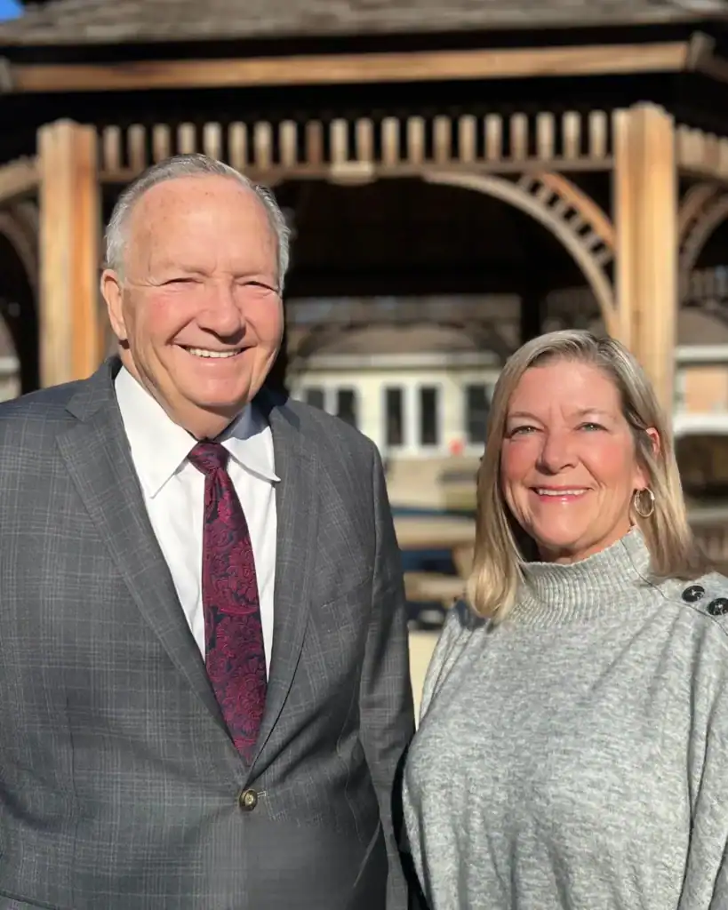 Dr. Ireland (CEO) and Julie Provan (VP & COO) standing on campus.