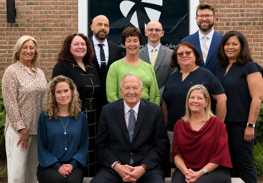 The Bello Machre Leadership Team poses for a group portrait outside the organization's headquarters.