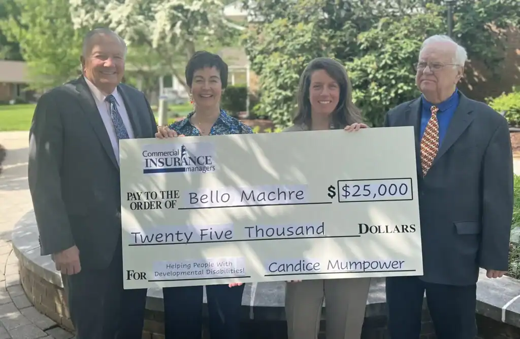 Tracy and Dr. Ireland accepting sponsorship check from Commercial Insurance Managers representatives.