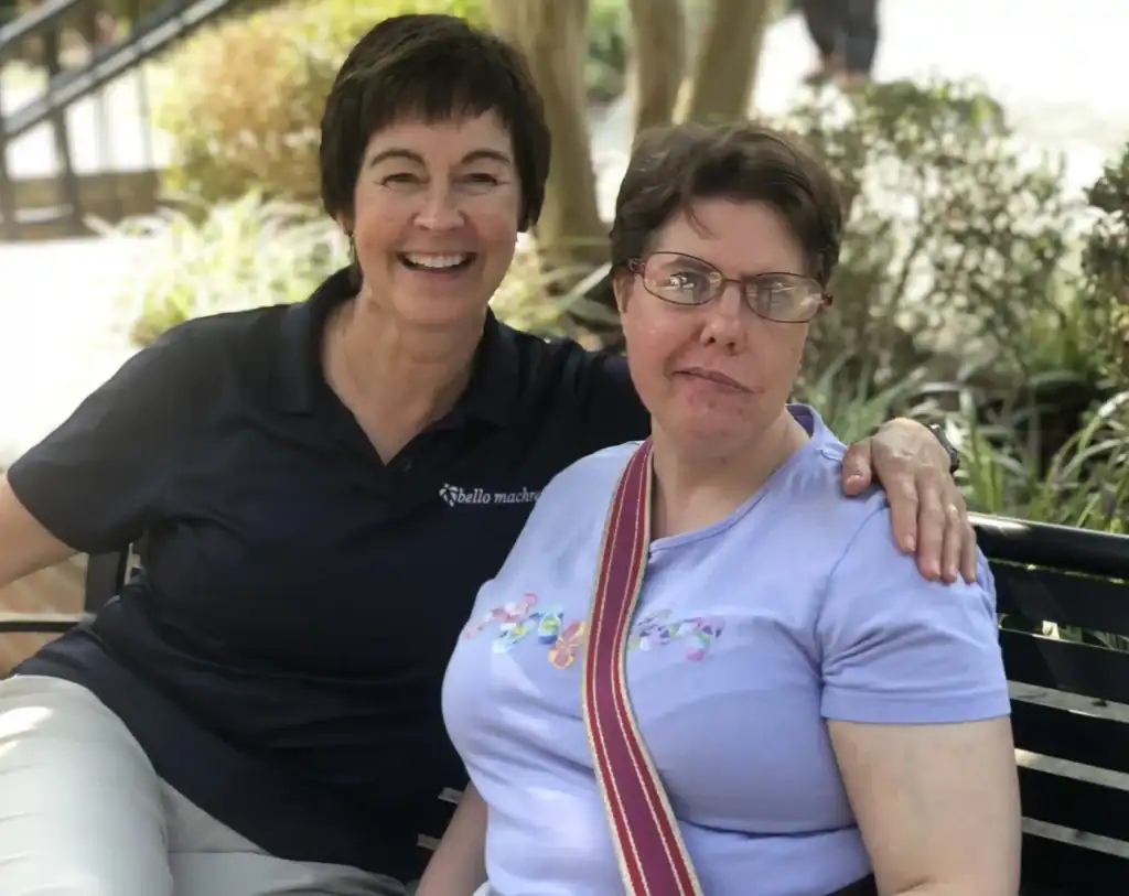 Tracy Lynott and Kathryn Wynkoop sitting on a bench in the Glen Burnie campus of Bello Machre.