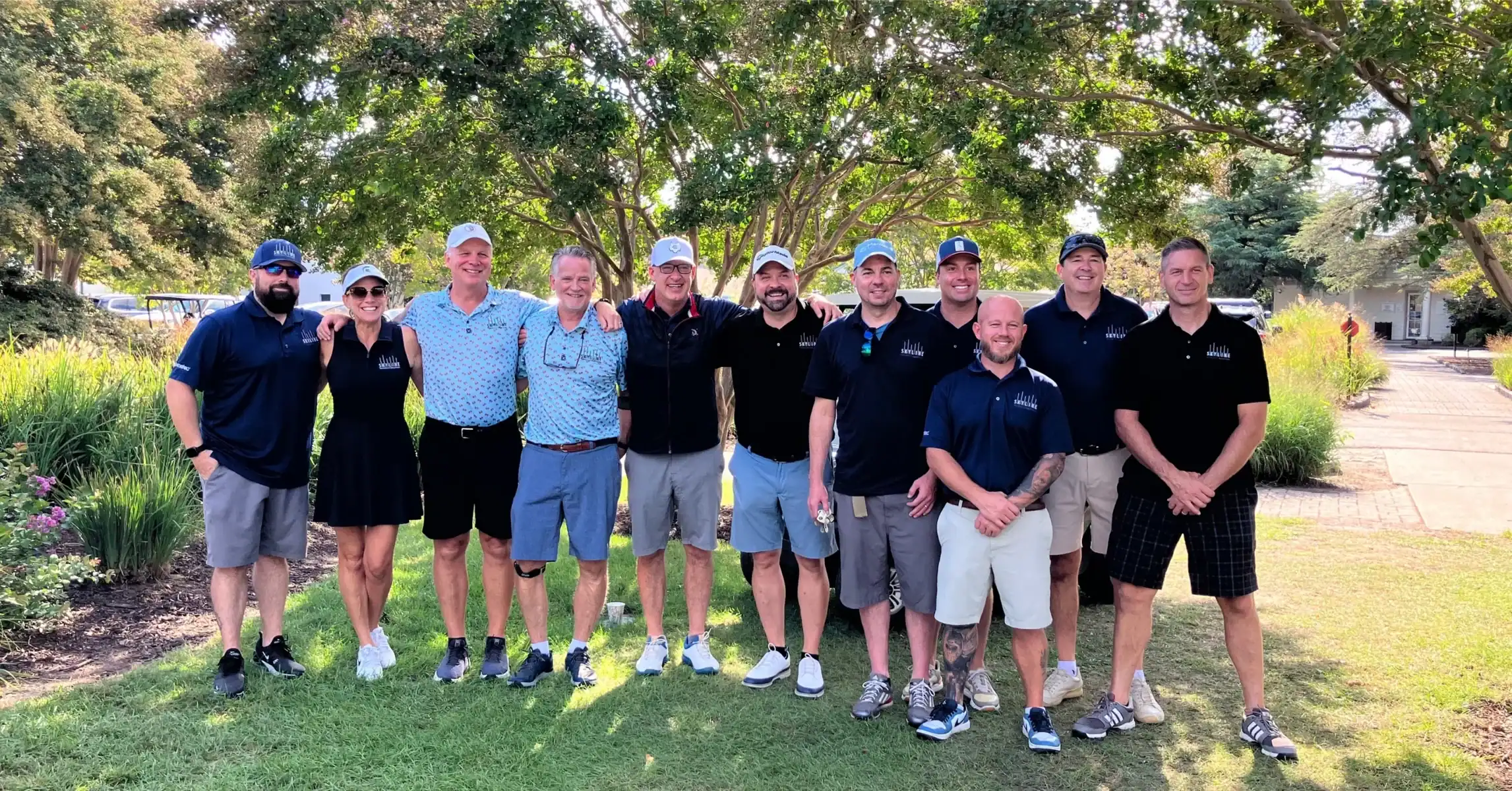 Group of golfers posing on the golf course.