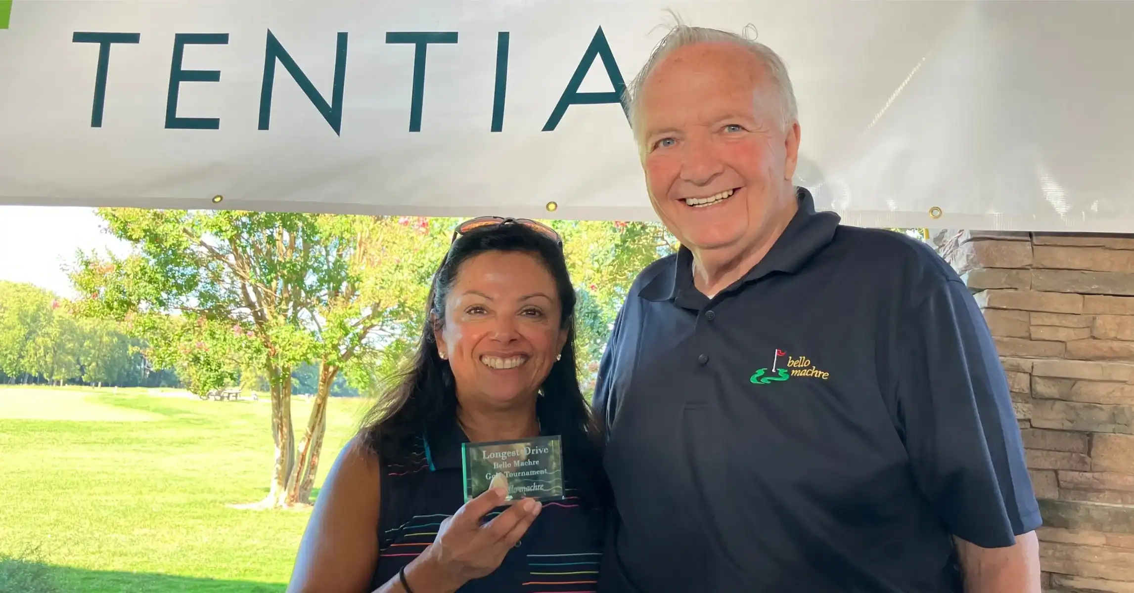 Dr. Ireland and sponsor posing at golf event.